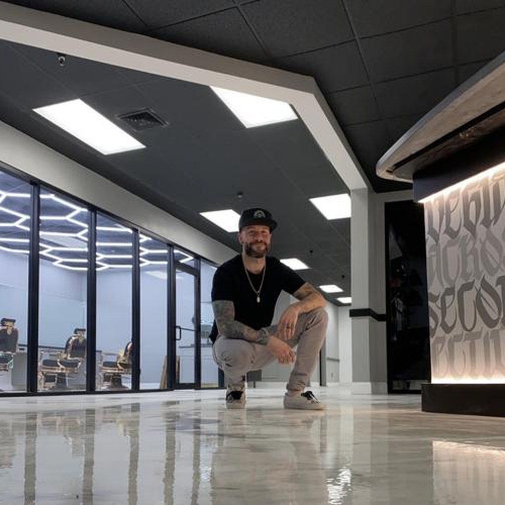 Matthew Brown, owner, at the front desk of Blvck Rose Collective